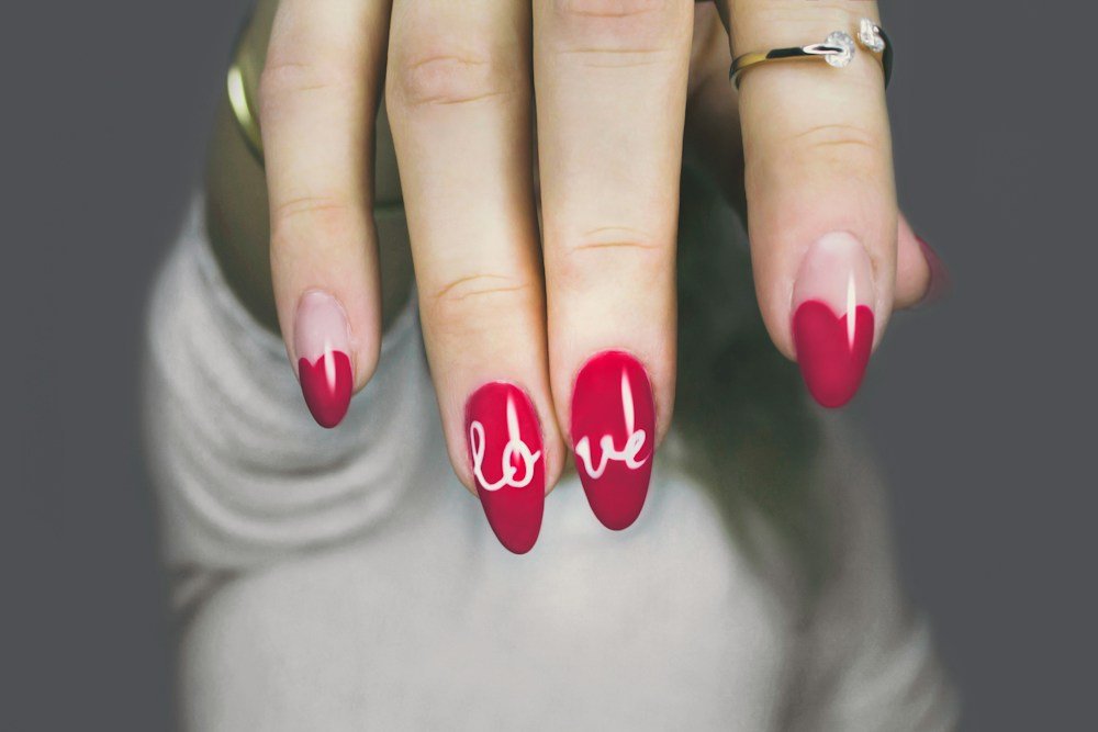 Red nail art with hand lettering